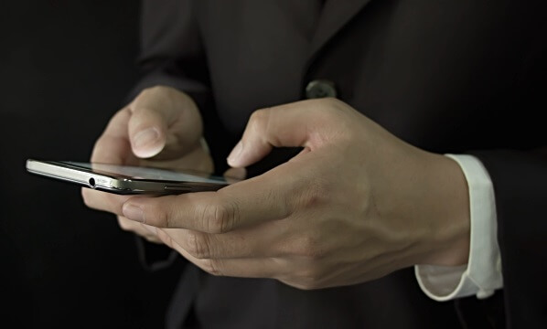 lawyer typing into mobile phone